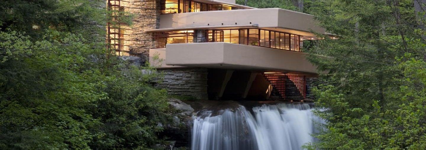 The Fallingwater Building - a house built into the side of a forest with water rushing out of the bottom.